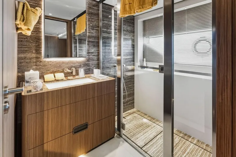 Slide: The Image of Luxurious 2018 Custom Line 120 yacht bathroom with modern wood and marble design. - 91
