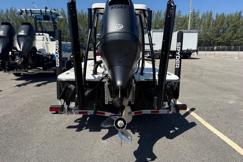 Slide: The Image of 2026 Spyder FX19 Vapor boat with powerful outboard motor, parked outdoors. - 15