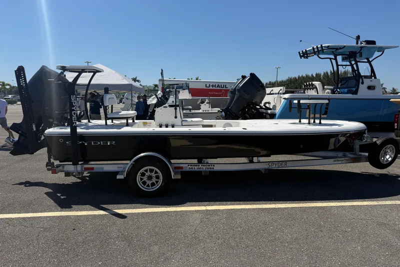 Slide: The Image of 2026 Spyder FX19 Vapor boat on trailer in sunny outdoor setting. - 16