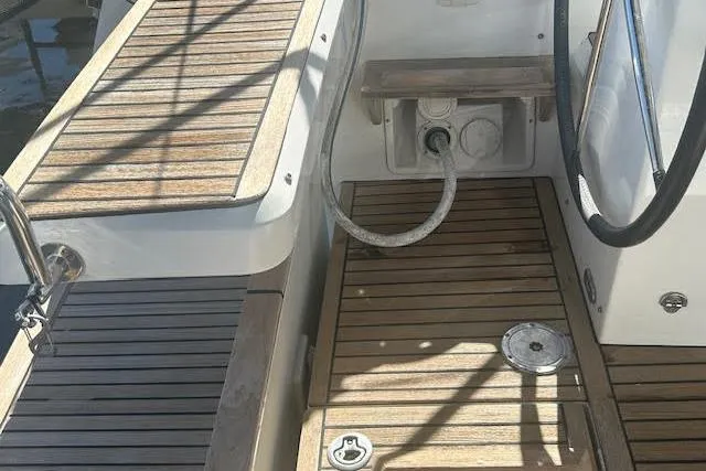 Slide: The Image of Cockpit view of 2013 Beneteau Sense 46 sailboat with teak flooring and equipment. - 26