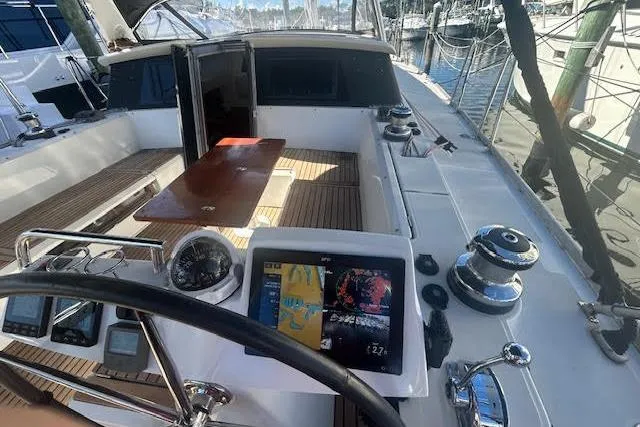 Slide: The Image of Cockpit controls of 2013 Beneteau Sense 46 yacht, featuring steering wheel and throttle. - 28