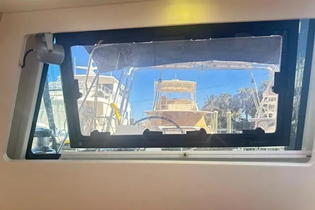 Slide: The Image of View from inside a 2013 Beneteau Sense 46 yacht, looking out at docked boats. - 33