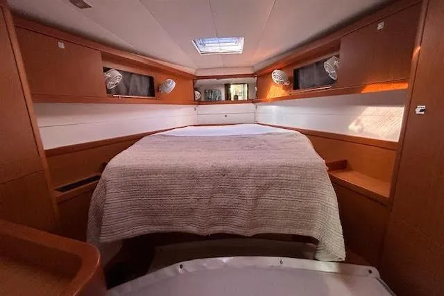 Slide: The Image of Cozy bedroom interior of 2013 Beneteau Sense 46 yacht with elegant wood finish. - 50