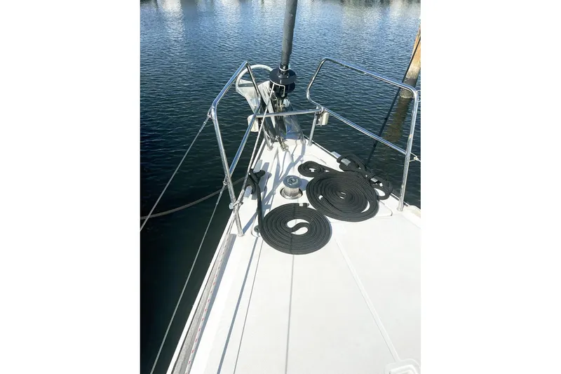 Slide: The Image of Bow of 2013 Beneteau Sense 46 sailboat with coiled ropes on deck. - 70