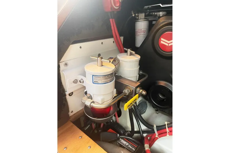 Slide: The Image of Engine compartment of 2013 Beneteau Sense 46 yacht, featuring fuel filters and wiring. - 74