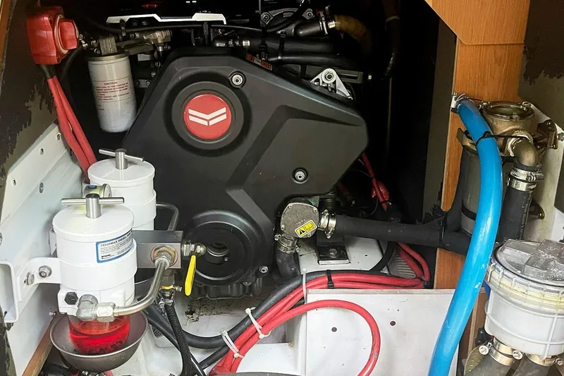 Slide: The Image of Engine compartment of a 2013 Beneteau Sense 46 sailboat, featuring various mechanical components. - 75