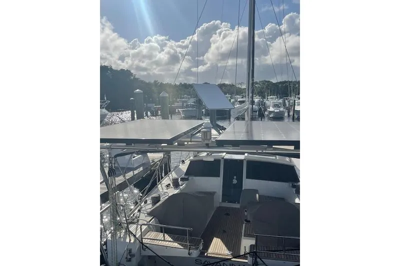 Slide: The Image of Sailboat Beneteau Sense 46, 2013 model, docked at marina under sunny skies. - 79