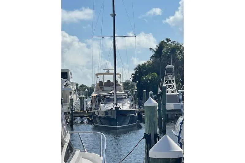 Slide: The Image of 2013 Beneteau Sense 46 yacht docked in a sunny marina setting. - 81