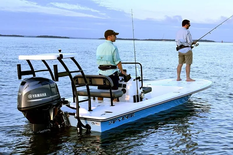 Slide: The Image of 2026 Spyder FX17 Flicker boat cruising on a calm lake with passengers. - 2