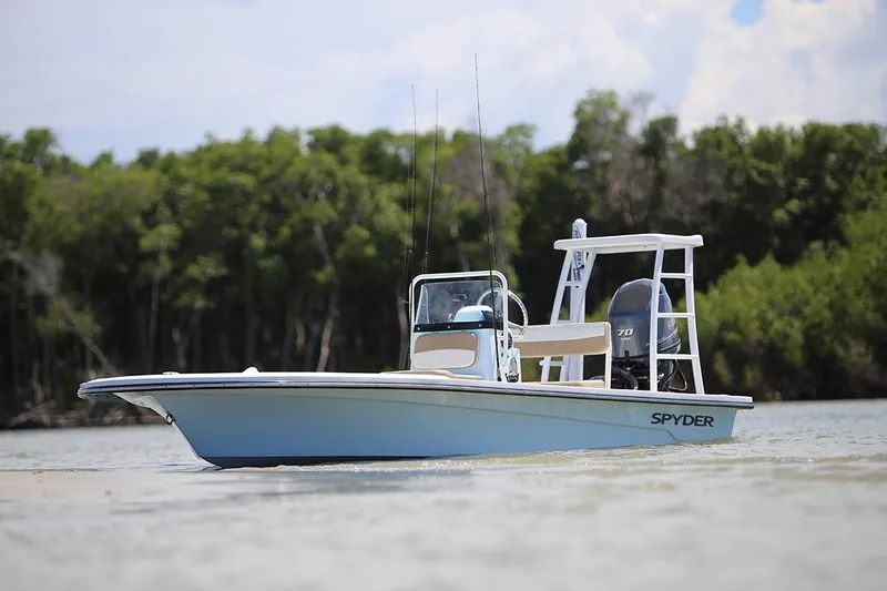 Slide: The Image of 2026 Spyder FX17 Flicker boat on calm water near lush green trees. - 8