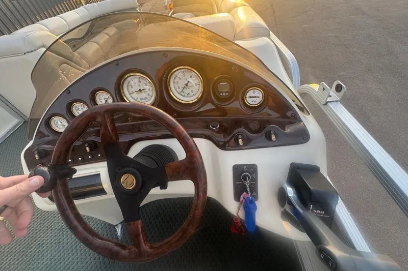Slide: The Image of Steering console of a 2002 Bennington 2550RL boat with gauges and controls. - 11