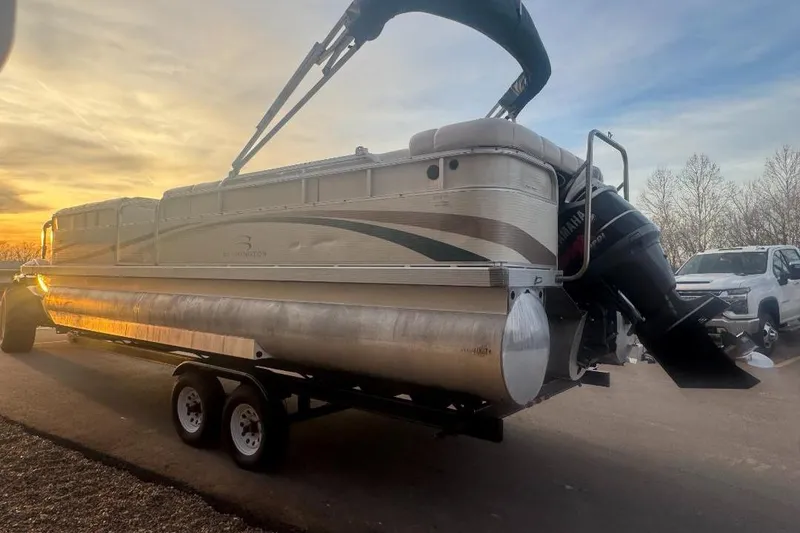 Slide: The Image of 2002 Bennington 2550RL pontoon boat on trailer at sunset, with Yamaha outboard motor. - 4