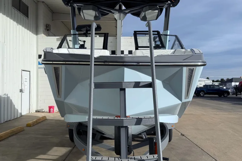 Slide: The Image of 2026 Nautique Super Air Nautique G21 boat on trailer, front view in outdoor setting. - 10