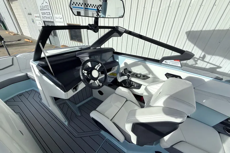 Slide: The Image of 2026 Nautique Super Air Nautique G21 boat interior with modern helm and seating. - 14