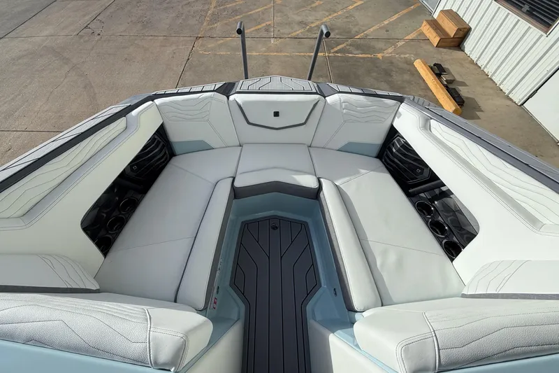 Slide: The Image of 2026 Nautique Super Air Nautique G21 boat interior with white seating and cup holders. - 16