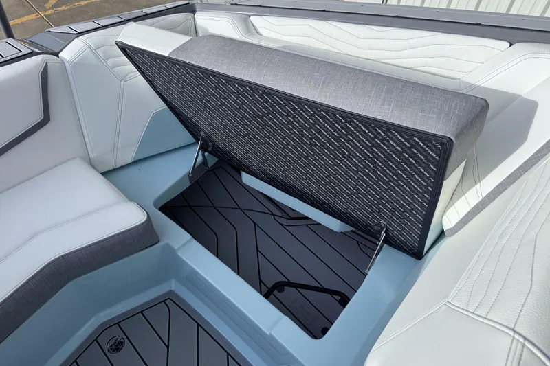 Slide: The Image of 2026 Nautique Super Air Nautique G21 interior with open storage compartment. - 22