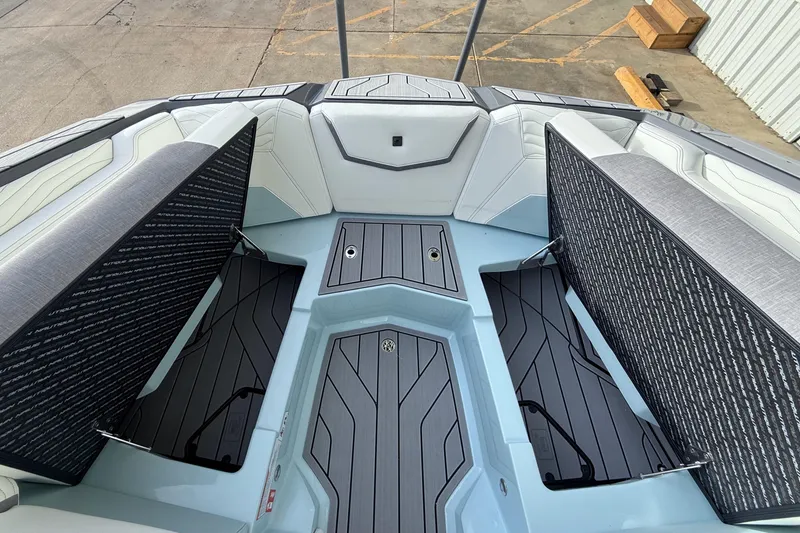 Slide: The Image of 2026 Nautique Super Air Nautique G21 boat interior with open storage compartments. - 24