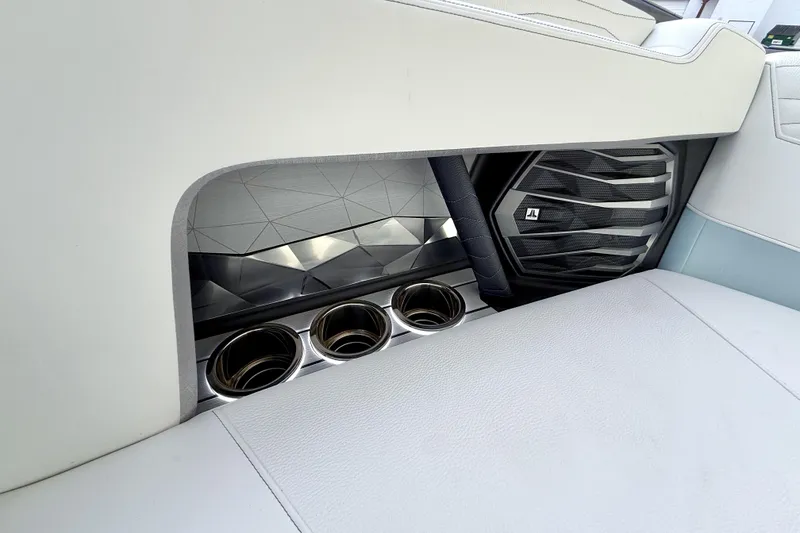 Slide: The Image of 2026 Nautique Super Air Nautique G21 interior with cup holders and speaker detail. - 25
