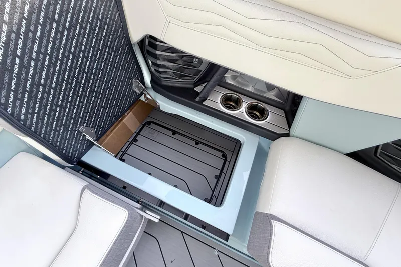 Slide: The Image of 2026 Nautique Super Air Nautique G21 interior storage and cup holders. - 26