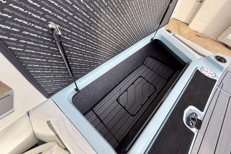 Slide: The Image of 2026 Nautique Super Air Nautique G21 storage compartment with open lid and sleek interior design. - 30