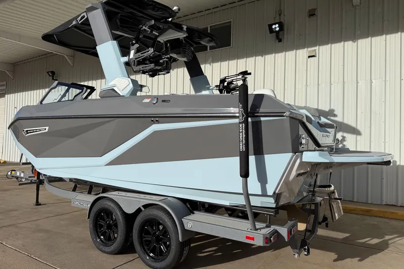 Slide: The Image of 2026 Nautique Super Air Nautique G21 boat on trailer, sleek design, parked outdoors. - 4