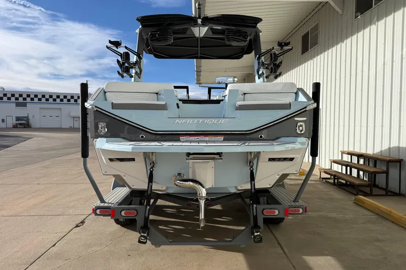 Slide: The Image of 2026 Nautique Super Air Nautique G21 boat rear view at a dock. - 5