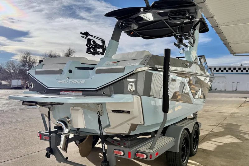 Slide: The Image of 2026 Nautique Super Air Nautique G21 boat on trailer, rear view, outdoors. - 6