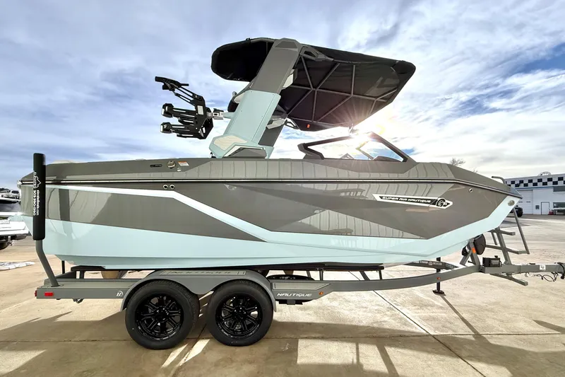 Slide: The Image of 2026 Nautique Super Air Nautique G21 boat on trailer, side view, sunny day. - 7
