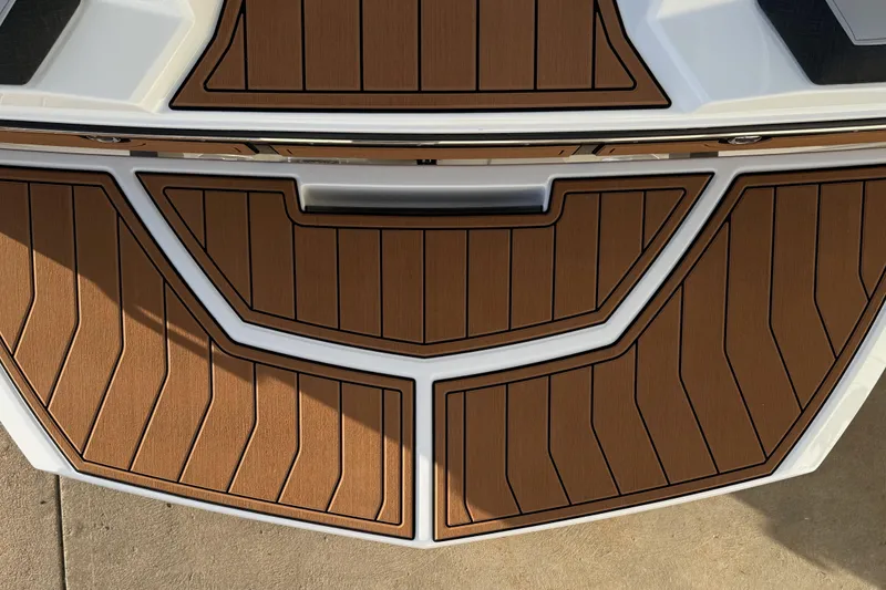 Slide: The Image of 2026 Nautique Super Air Nautique GS22 boat deck with brown and white design. - 11