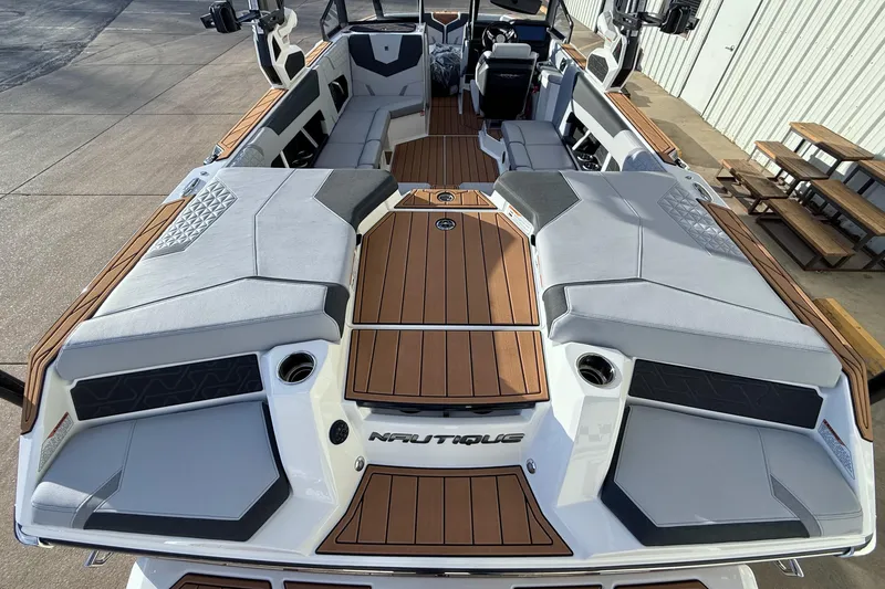 Slide: The Image of 2026 Nautique Super Air Nautique GS22 boat interior with sleek seating and wood accents. - 12