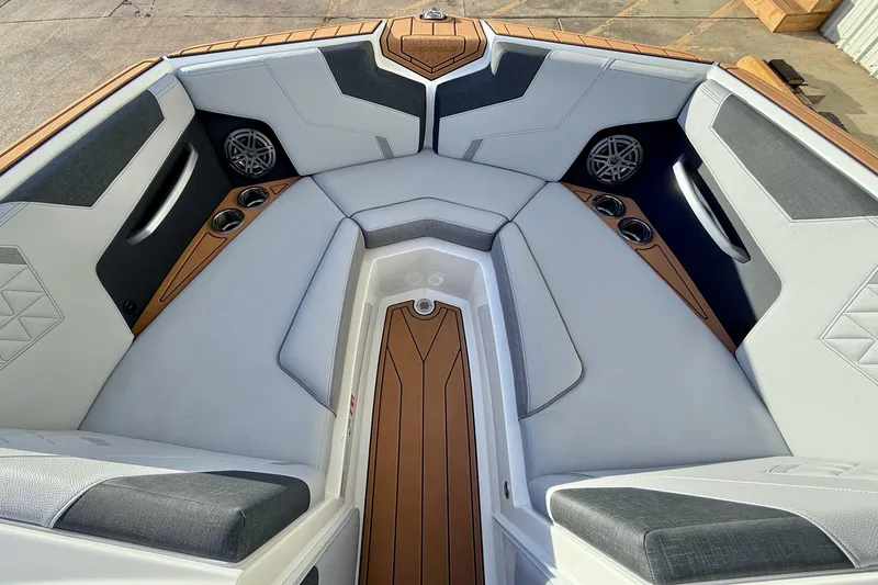 Slide: The Image of Interior of 2026 Nautique Super Air Nautique GS22 boat with luxury seating and speakers. - 15