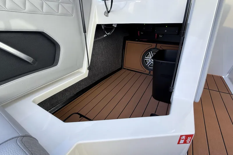 Slide: The Image of 2026 Nautique Super Air Nautique GS22 interior storage with speaker and wood flooring. - 16