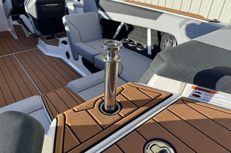 Slide: The Image of 2026 Nautique Super Air Nautique GS22 interior with teak flooring and stainless steel features. - 27
