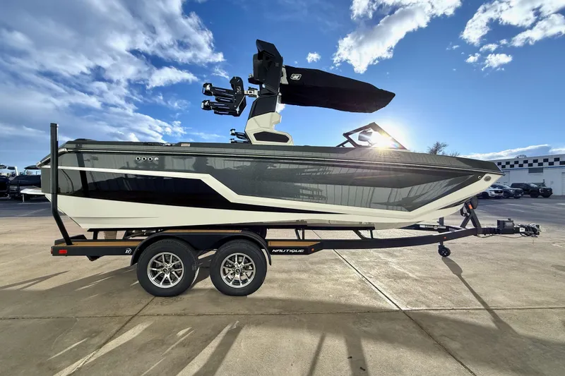 Slide: The Image of 2026 Nautique Super Air Nautique GS22 boat on trailer under blue sky. - 8