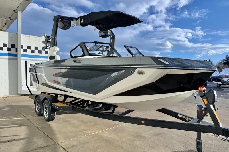 Slide: The Image of 2026 Nautique Super Air Nautique GS22 boat on trailer, parked outdoors under blue sky. - 9