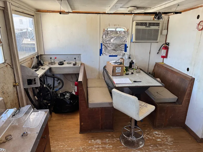 Slide: The Image of Interior of a 1971 Butterfish Fishing Trawler with seating, table, and equipment. - 15