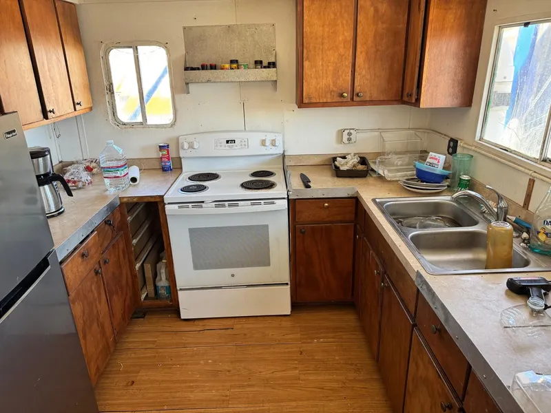 Slide: The Image of 1971 Butterfish Fishing Trawler kitchen with wooden cabinets and appliances. - 16