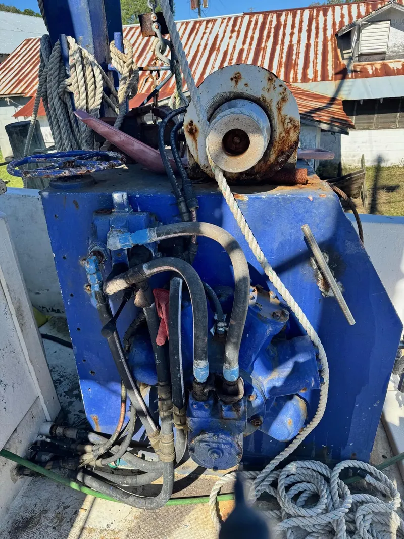 Slide: The Image of Rusty machinery on a 1971 Butterfish Fishing Trawler, featuring ropes and cables. - 18