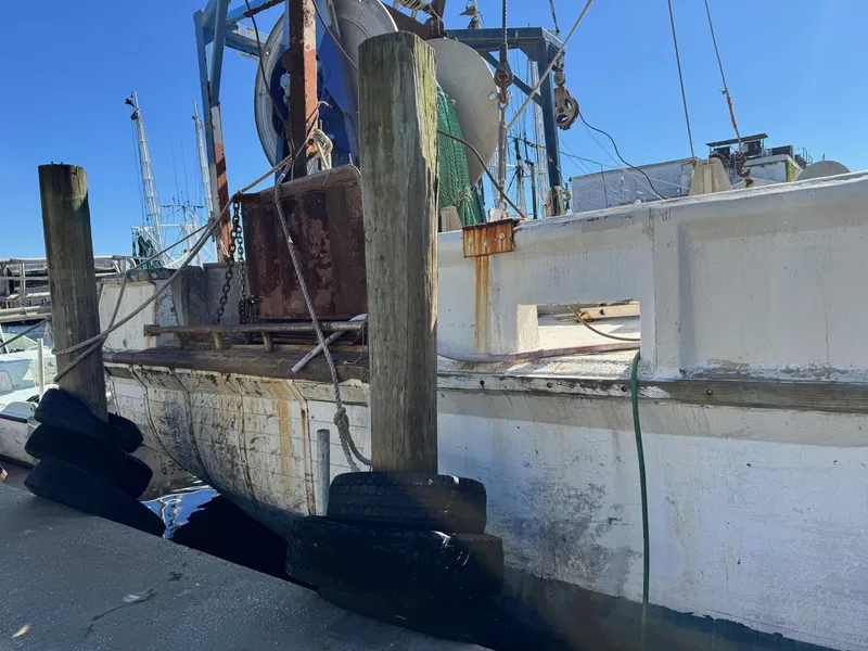 Slide: The Image of 1971 Butterfish Fishing Trawler docked at a marina, showing weathered hull and equipment. - 21