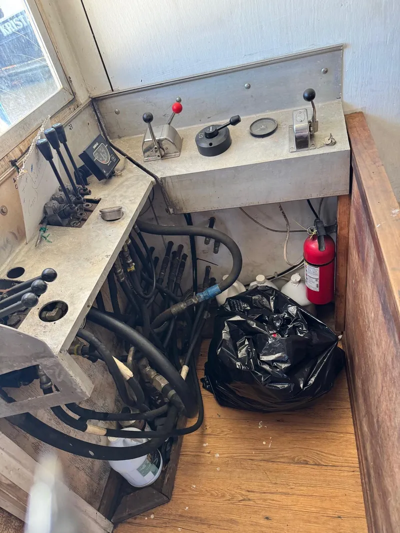 Slide: The Image of Control panel of a 1971 Butterfish Fishing Trawler with levers and fire extinguisher. - 8