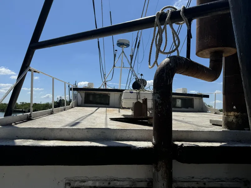 Slide: The Image of 1972 commercial shrimp freezer trawler deck with rigging and equipment under clear sky. - 16
