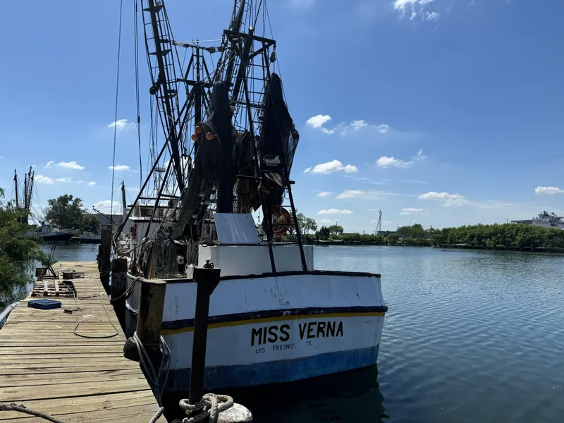 Slide: The Image of 1972 Commercial Shrimp Freezer Trawler "Miss Verna" docked by calm waters. - 2