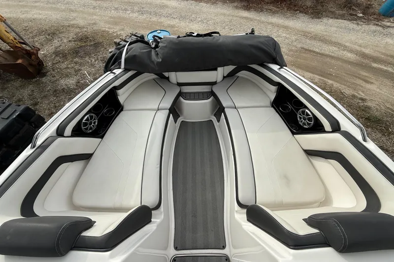Slide: The Image of 2019 Yamaha Boats 242 Limited S interior with white seating and speakers. - 10