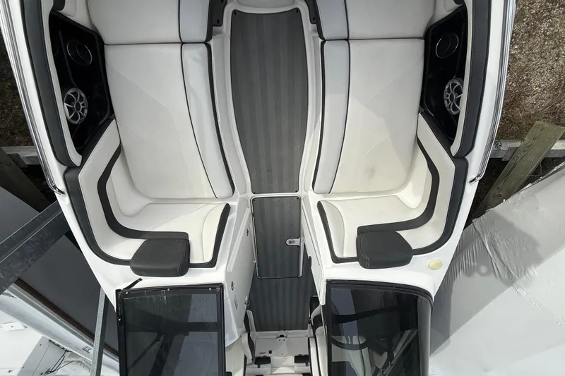 Slide: The Image of 2019 Yamaha Boats 242 Limited S interior with white seating and black accents. - 11