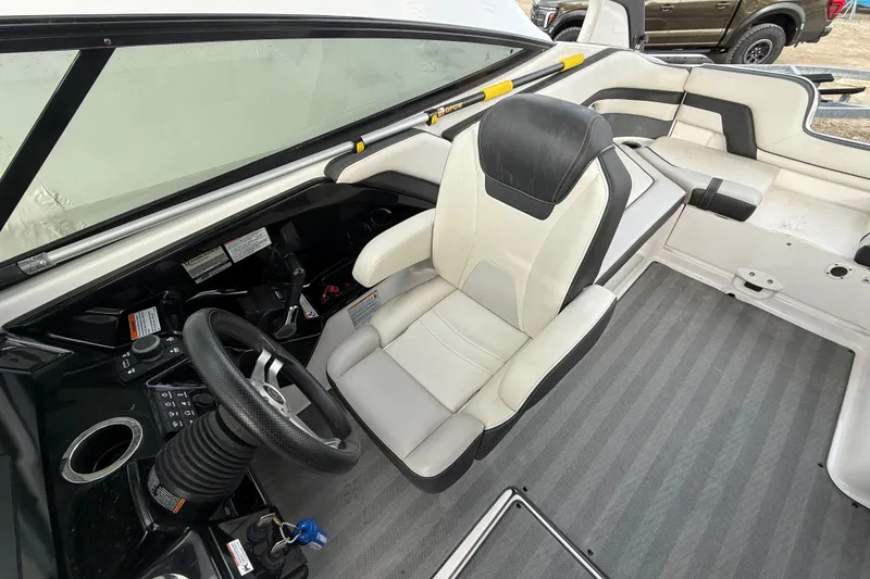 Slide: The Image of 2019 Yamaha Boats 242 Limited S interior with steering wheel and seating. - 6