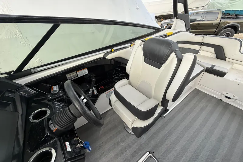 Slide: The Image of 2019 Yamaha Boats 242 Limited S interior with steering wheel and seating. - 7