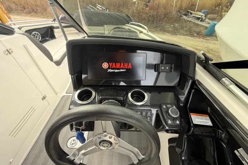 Slide: The Image of 2019 Yamaha Boats 242 Limited S dashboard with steering wheel and control panel. - 9