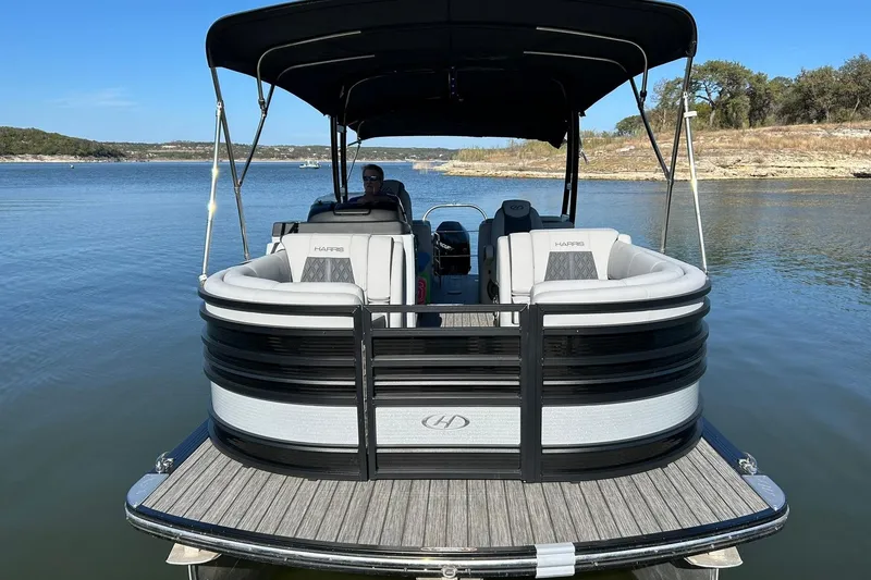 Slide: The Image of 2020 Harris FloteBote Solstice 230 pontoon boat on a serene lake. - 10
