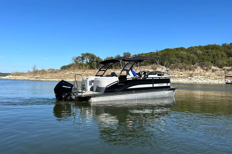 Slide: The Image of 2020 Harris FloteBote Solstice 230 pontoon boat on a serene lake. - 17