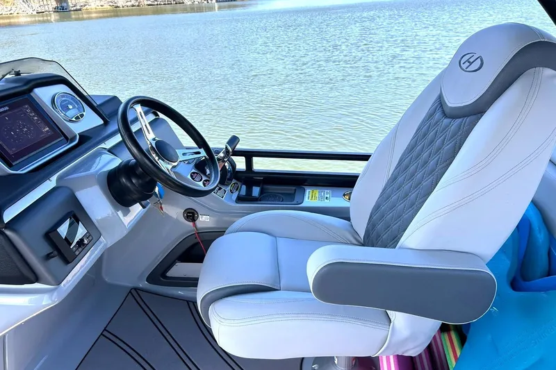 Slide: The Image of Captain's seat and helm of 2020 Harris FloteBote Solstice 230 on calm water. - 33
